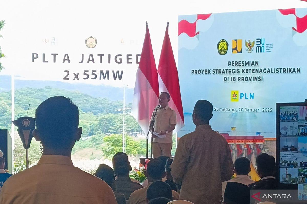 Officials and Indonesian flags at a PLN power infrastructure inauguration ceremony