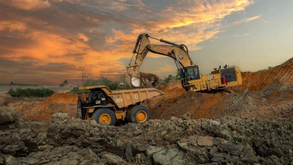 Heavy excavation equipment clearing land at a mining site
