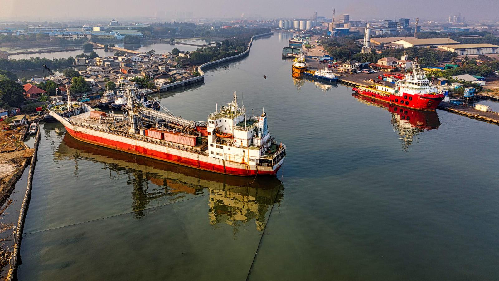 Solar panels installed on the deck of an Indonesian oil barge or cargo support vessel at sea, representing maritime decarbonization