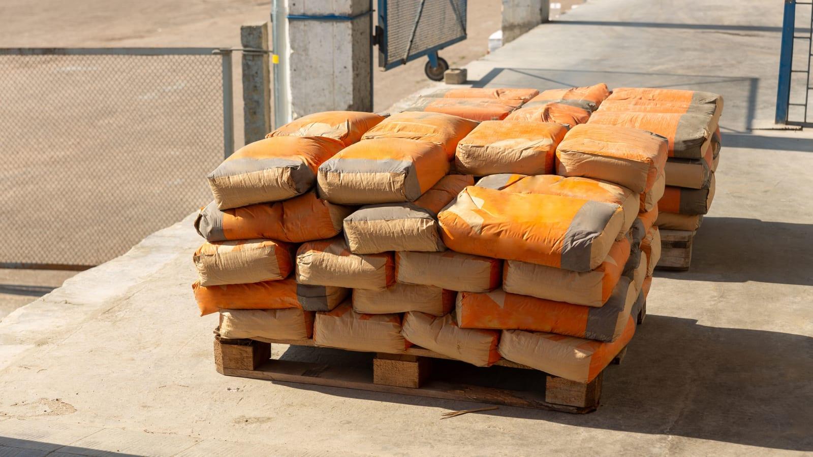Baled refuse derived fuel beside a cement plant conveyor and kiln in South Sumatra